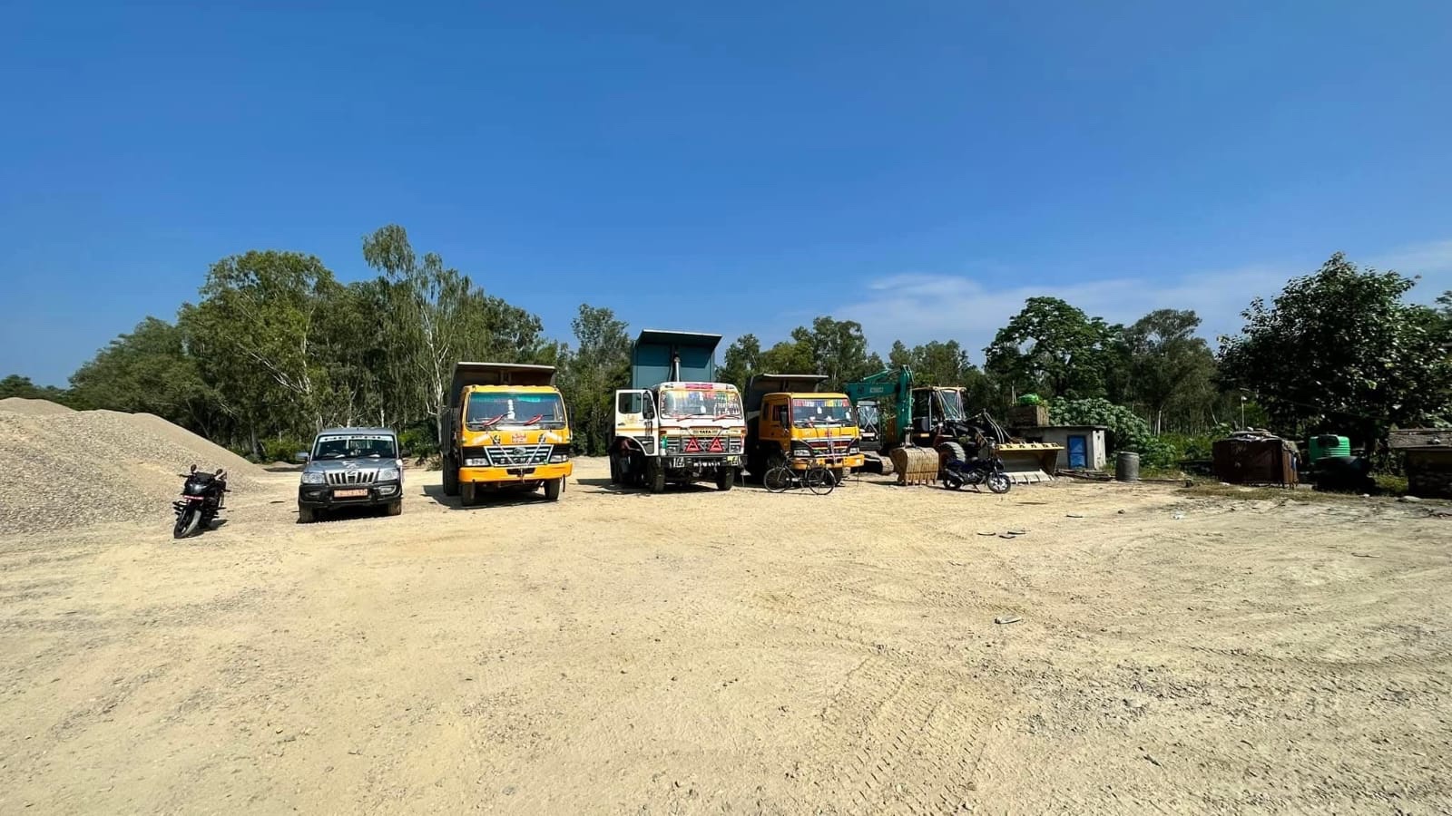Puru's construction vehicles and heavy equipment gathered in an open work yard