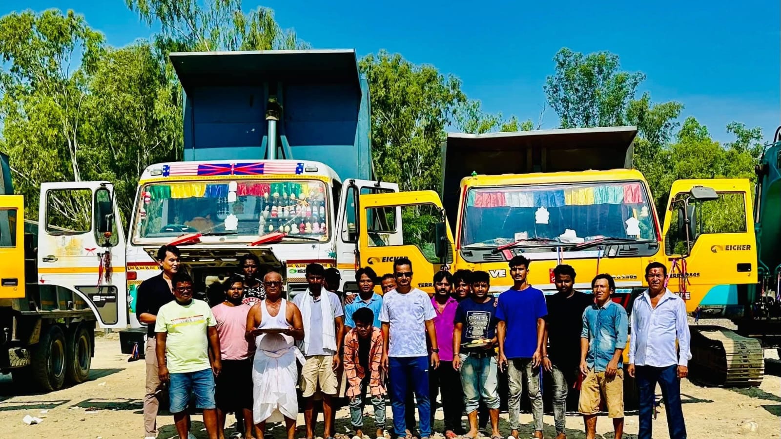 Puru field team and construction vehicles at a work site